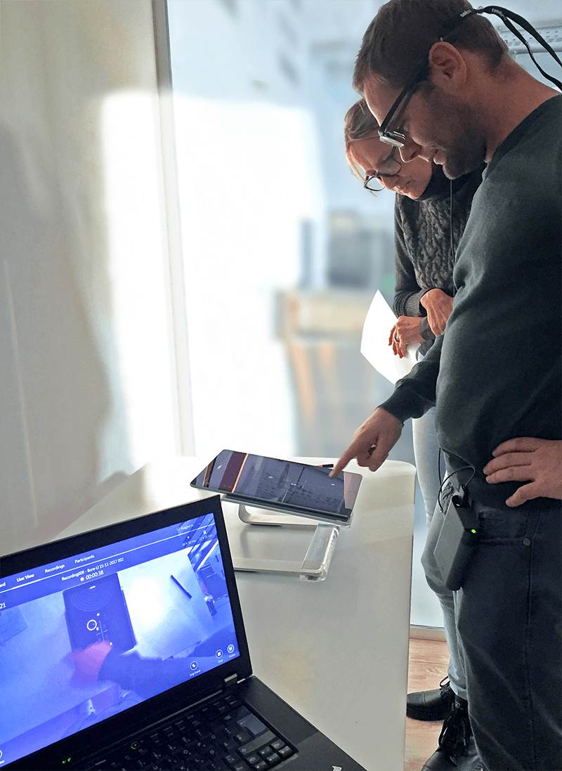 In our internal usability lab, a test person, led by our colleague Veronika, tests the BORA Pure user interface on a tablet. The participant wears eye-tracking glasses.